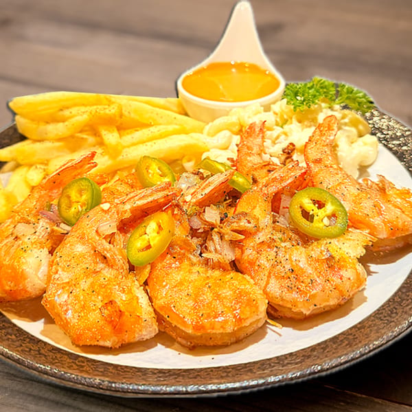 Hana Hawaiian BBQ plate with grilled shrimp, french fries, macaroni salad, and dipping sauce.